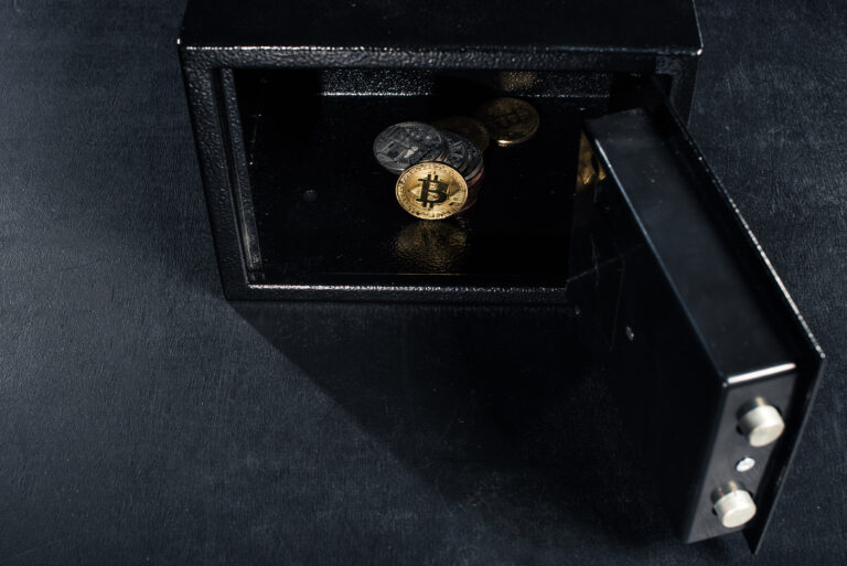 Bitcoin cryptocurrency stacked in open strongbox